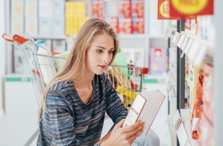 Woman checking ingredients in supermarket