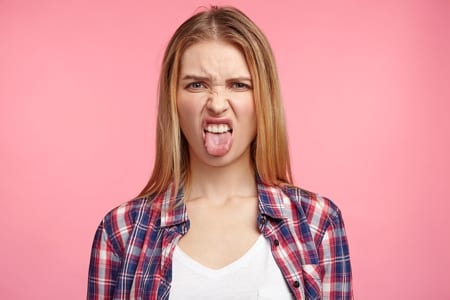 Woman pulling a disgusted face