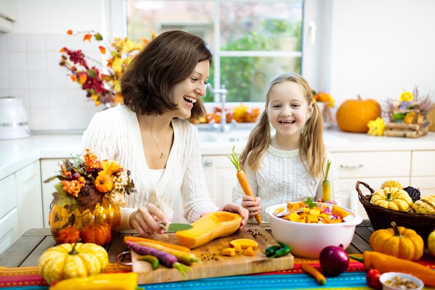 Mother & daughter making butternut squash soup