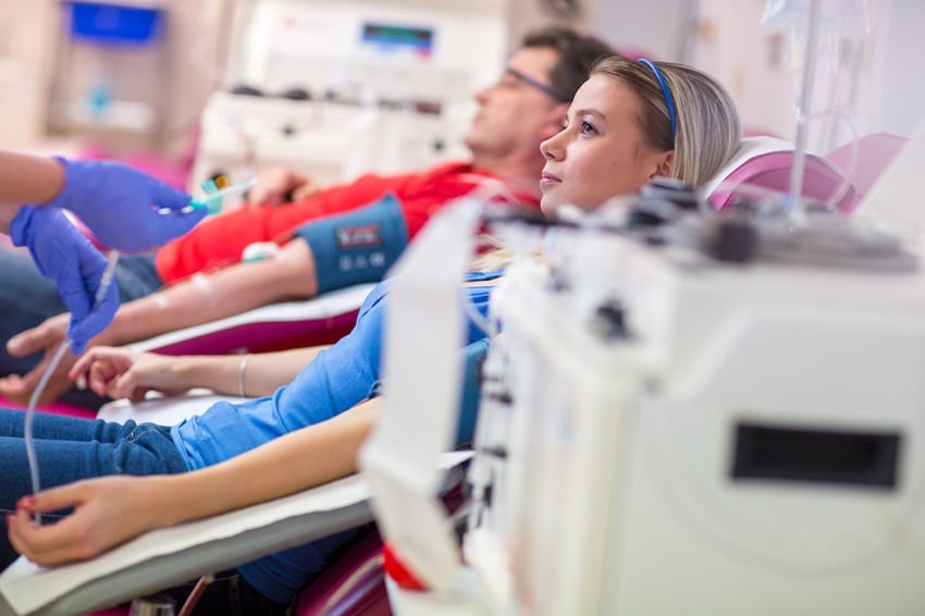 Man & woman donating blood