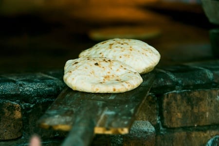 Pita puffs as it cooks to create the pocket