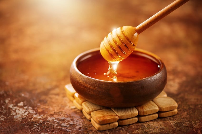 Honey dripping from a spoon