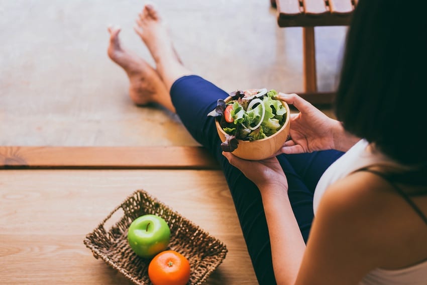 Vegan woman eating a salad