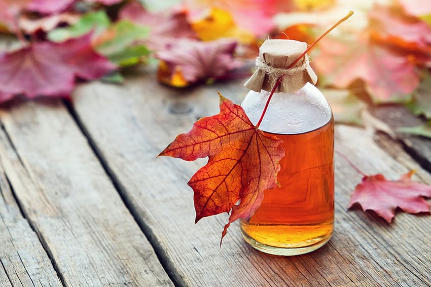 Maple syrup on autumnal table