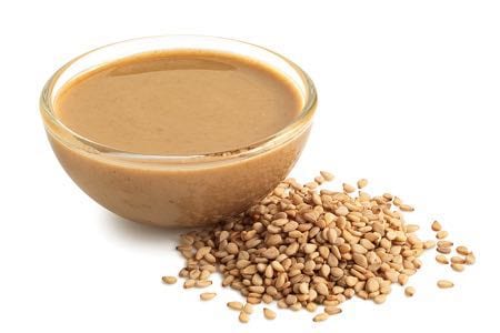 Tahini in a glass bowl with sesame seeds