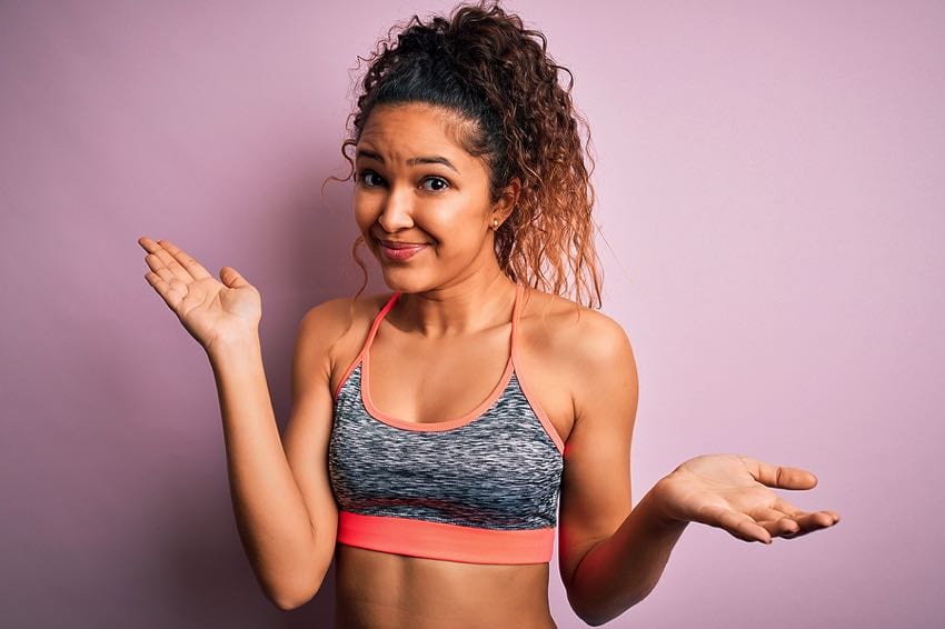 Woman exercising looking confused