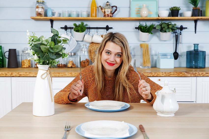 Woman sitting with empty plate